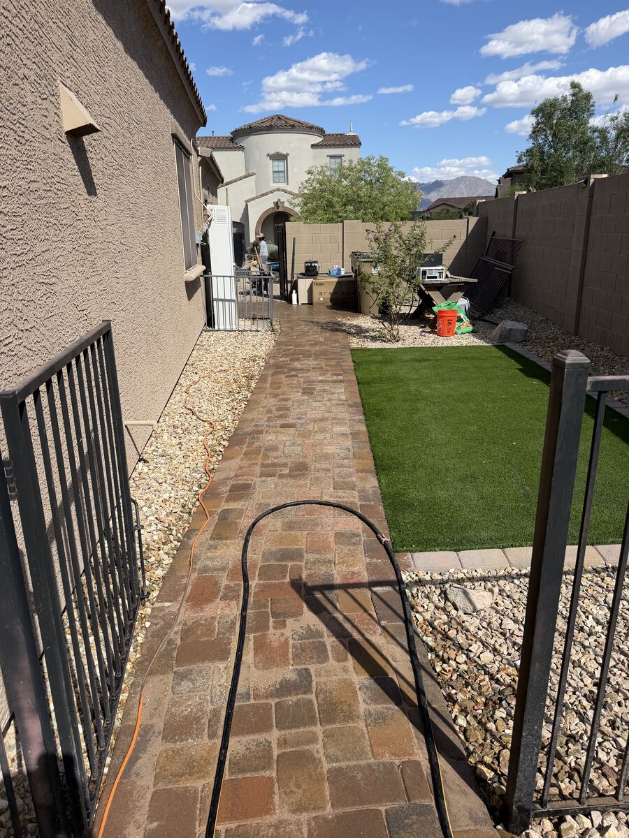Residential backyard with pavers, gravel, artificial turf and seating area