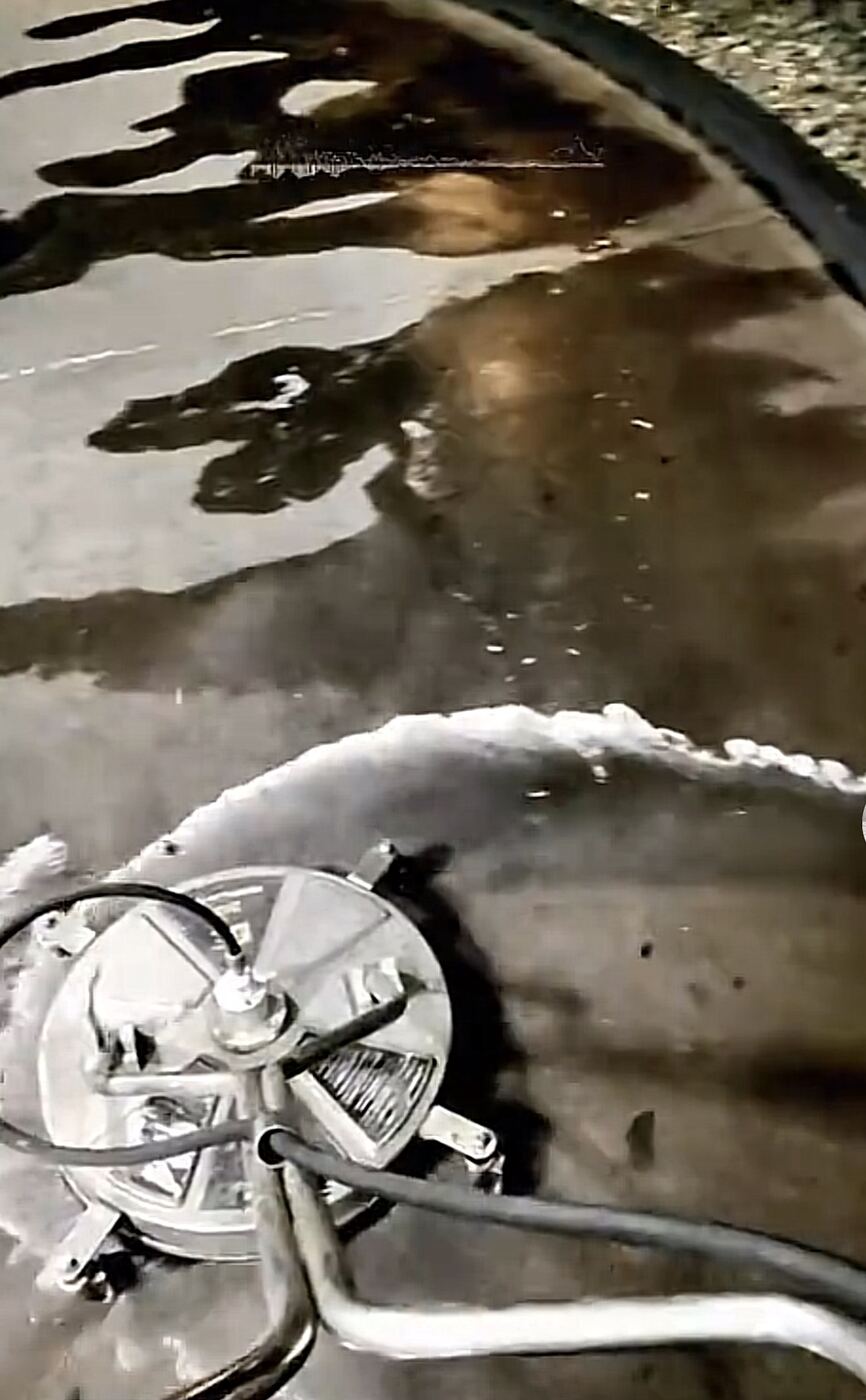 Close-up of pressure washing surface cleaner attachment